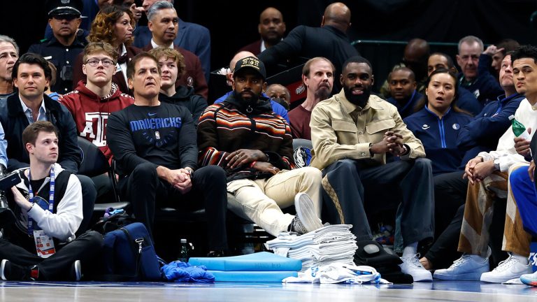 Mark Cuban, Kyrie Irving and Tim Hardaway Jr. sit courtside during the game against the Chicago Bulls at American Airlines Center on April 07, 2023. (Photo by Tim Heitman/Getty Images)