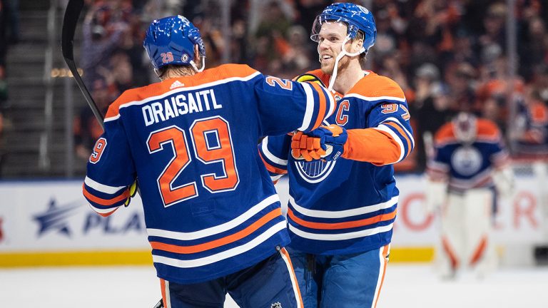 Edmonton Oilers' Connor McDavid  and Leon Draisaitl celebrate a goal against the Arizona Coyotes during overtime NHL action in Edmonton on Wednesday March 22, 2023. (Jason Franson/CP)