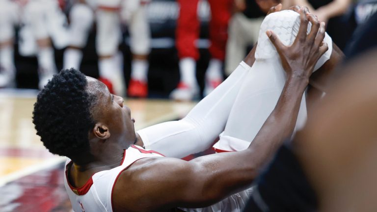 Miami Heat guard Victor Oladipo (4) is injured during the second half of Game 3 in a first-round NBA basketball playoff series against the Milwaukee Bucks, Saturday, April 22, 2023, in Miami. (Al Diaz/Miami Herald via AP)