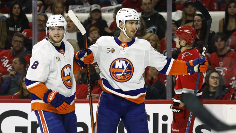 New York Islanders' Pierre Engvall, right, celebrates his goal against the Carolina Hurricanes with Noah Dobson (8) during the first period of Game 5 of an NHL hockey Stanley Cup first-round playoff series in Raleigh, N.C., Tuesday, April 25, 2023. (Karl B DeBlaker/AP)