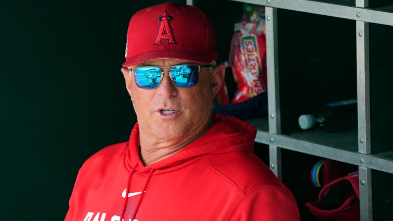 Los Angeles Angels manager Phil Nevin sits in the dugout prior to a spring training baseball game against the Cincinnati Reds, Monday, March 20, 2023, in Goodyear, Ariz. (Ross D. Franklin/AP)