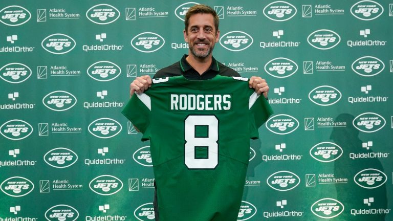 New York Jets quarterback Aaron Rodgers poses with a jersey after a news conference at the NFL football team's training facility in Florham Park, N.J., Wednesday, April 26, 2023. (Seth Wenig/AP)