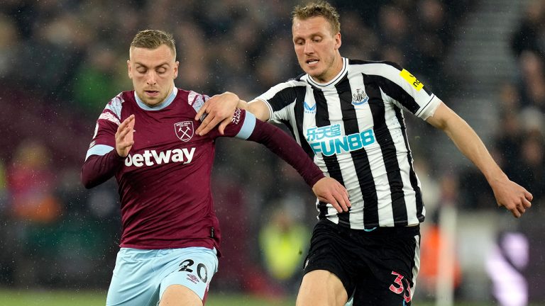 West Ham's Jarrod Bowen, left, challenges for the ball with Newcastle's Dan Burn during the English Premier League soccer match between West Ham United and Newcastle United at The London stadium in London, Wednesday, April 5, 2023. (Kirsty Wigglesworth/AP)