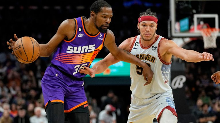 Phoenix Suns forward Kevin Durant (35) drives as Denver Nuggets forward Aaron Gordon (50) defends during the second half of an NBA basketball game, Friday, March 31, 2023, in Phoenix. (Matt York/AP)