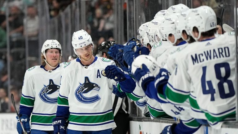 Vancouver Canucks centre Elias Pettersson, second from left, celebrates his goal with teammates on the bench as he is followed by right wing Brock Boeser during the first period of an NHL hockey game against the Anaheim Ducks Tuesday, April 11, 2023, in Anaheim, Calif. (Mark J. Terrill/AP Photo)