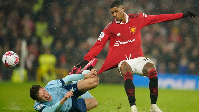 Manchester United's Marcus Rashford, right, challenges for the ball with Brentford's Aaron Hickey during the English Premier League soccer match between Manchester United and Brentford, at the Old Trafford stadium in Manchester, England, Wednesday, April 5, 2023. (Dave Thompson/AP)