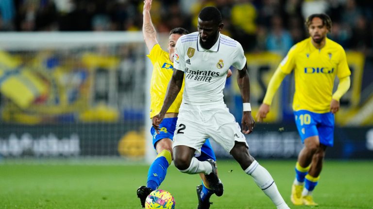 Real Madrid's Antonio Rudiger, centre, and Cadiz's Fede San Emeterio, left, challenge for the ball during the Spanish La Liga soccer match between Cadiz CF and Real Madrid at the Nuevo Mirandilla stadium in Cadiz, Spain, Saturday, April 15, 2023. (Jose Breton/AP)