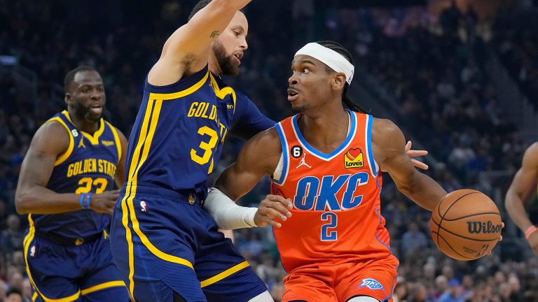 Oklahoma City Thunder guard Shai Gilgeous-Alexander (2) drives to the basket against Golden State Warriors guard Stephen Curry during the first half of an NBA basketball game in San Francisco, Tuesday, April 4, 2023. (Jeff Chiu/AP)