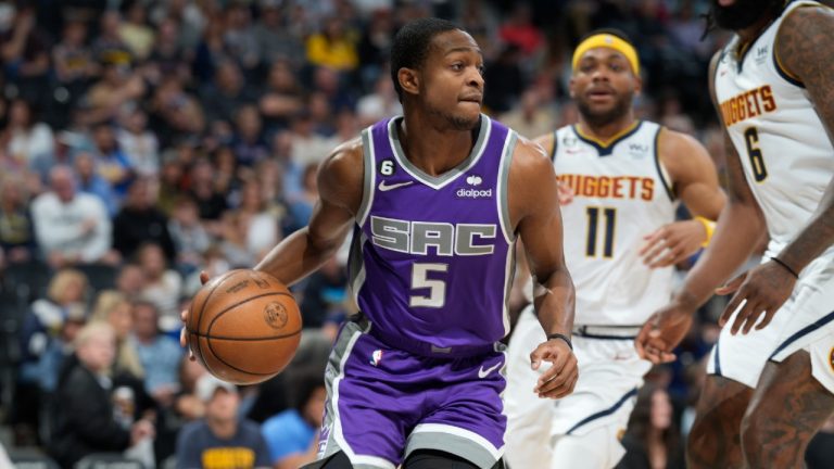 Sacramento Kings guard De'Aaron Fox, left, looks to pass the ball after driving past Denver Nuggets centre DeAndre Jordan, front right, and forward Bruce Brown in the first half of an NBA basketball game Sunday, April 9, 2023, in Denver. (David Zalubowski/AP)