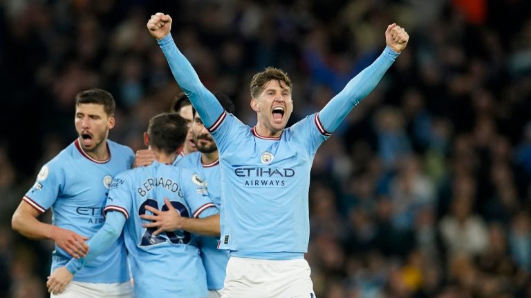 Manchester City's John Stones, right, celebrates after scoring his side's second goal during the English Premier League soccer match between Manchester City and Arsenal at Etihad stadium in Manchester, England, Wednesday, April 26, 2023. (Dave Thompson/AP)