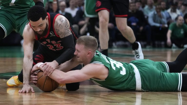 Boston Celtics forward Sam Hauser, right, and Toronto Raptors guard Fred VanVleet (23) go to the court for the ball during the first half of an NBA basketball game Wednesday, April 5, 2023, in Boston. (Charles Krupa/AP)