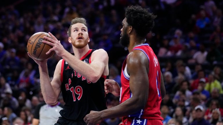 Toronto Raptors' Jakob Poeltl looks to shoot against Philadelphia 76ers' Joel Embiid during the first half of an NBA basketball game Friday, March 31, 2023, in Philadelphia. (Matt Rourke/AP)