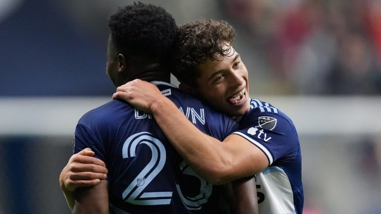 Vancouver Whitecaps' Sebastian Berhalter, right, and Javain Brown celebrate Brown's second goal against CF Montreal during the second half of an MLS soccer game in Vancouver, on Saturday, April 1, 2023. (Darryl Dyck/CP)