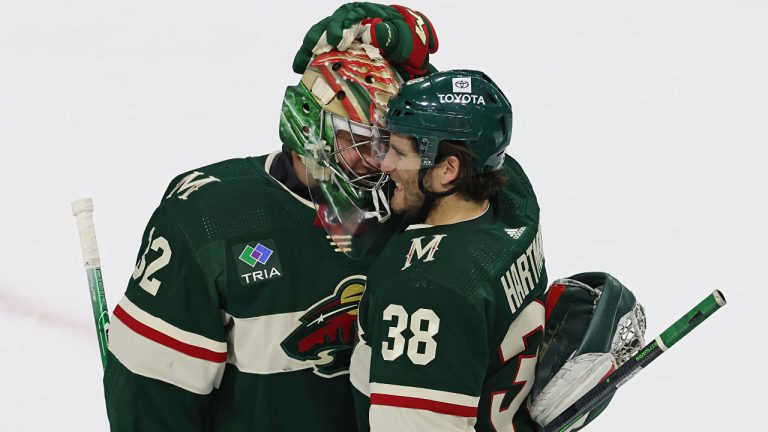 Minnesota Wild right wing Ryan Hartman (38) celebrates with goaltender Filip Gustavsson (32) after the team's 5-1 over the Dallas Stars in Game 3 of an NHL hockey Stanley Cup first-round playoff series Friday, April 21, 2023, in St. Paul, Minn. (Stacy Bengs/AP)