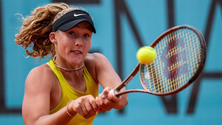 Mirra Andreeva of Russia returns the ball to Magda Linette of Poland during their match at the Madrid Open tennis tournament in Madrid, Spain, Saturday, April 29, 2023. (Manu Fernandez/AP)