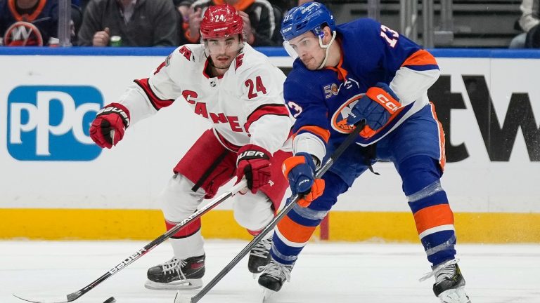 New York Islanders center Mathew Barzal, right, and Carolina Hurricanes center Seth Jarvis (24) vie for control of the puck during the first period Game 3 in an NHL hockey Stanley Cup first-round playoff series Friday, April 21, 2023, in Elmont, N.Y. (Bryan Woolston/AP)