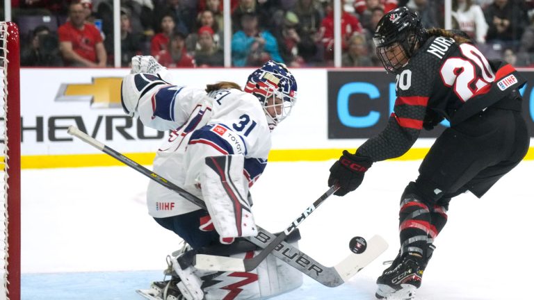 Canada forward Sarah Nurse (20) gets stopped by USA goaltender Aerin Frankel (31) during first period IIHF Women's World Hockey Championship hockey action in Brampton, Ont., on Monday, April 10, 2023. (Nathan Denette/CP)