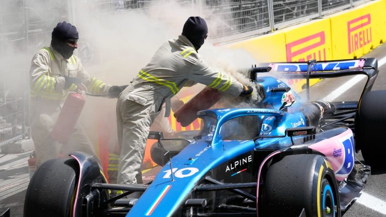 Course marshals extinguish an engine fire in a car of Alpine driver Pierre Gasly of France during a practice session at the Baku circuit, in Baku, Azerbaijan, Friday, April 28, 2023. The Formula One Grand Prix will be held on Sunday April 30, 2023. (Sergei Grits/AP)