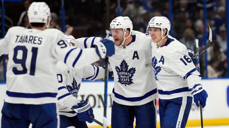 Toronto Maple Leafs defenseman Morgan Rielly (44) celebrates his goal against the Tampa Bay Lightning with right wing Mitchell Marner (16) and center John Tavares (91) during the third period in Game 4 of an NHL hockey Stanley Cup first-round playoff series Monday, April 24, 2023, in Tampa, Fla. (Chris O'Meara/AP Photo)