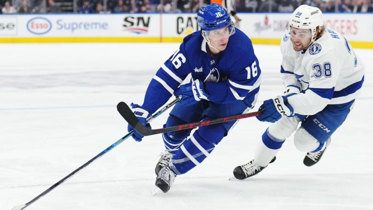 Toronto Maple Leafs forward Mitchell Marner (16) protects the puck from Tampa Bay Lightning forward Brandon Hagel (38) during second period NHL Stanley Cup playoff hockey action in Toronto on Thursday, April 27, 2023. (Nathan Denette/THE CANADIAN PRESS)