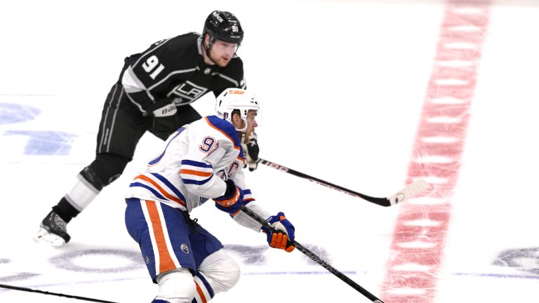 Edmonton Oilers' Connor McDavid controls the puck past Los Angeles Kings' Carl Grundstrom (91) during the first period in Game 6 of an NHL hockey Stanley Cup first-round playoff series in Los Angeles on Saturday, April 29, 2023. (Keith Birmingham/The Orange County Register via AP)