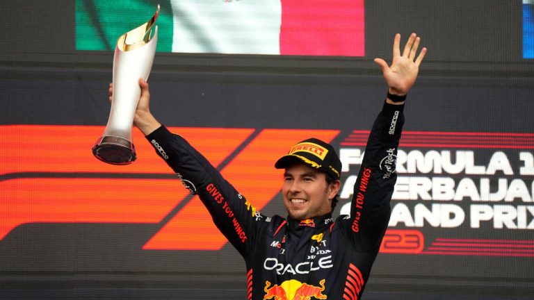 Red Bull driver Sergio Perez of Mexico celebrates on the podium as he won the Formula One Grand Prix at the Baku circuit in Baku, Azerbaijan, Sunday, April 30, 2023. (Sergei Grits/AP)