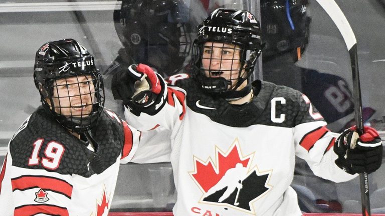 Marie-Philip Poulin (29) of Canada celebrates with teammate Brianne Jenner (19) after scoring against the USA during second period Rivalry Series hockey action in Laval, Que., Wednesday, February 22, 2023. (Graham Hughes/CP)