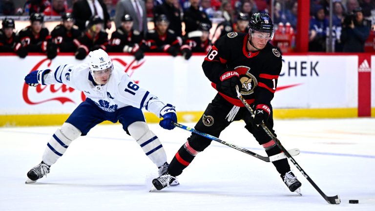 Ottawa Senators left wing Tim Stutzle (18) takes the puck from Toronto Maple Leafs right wing Mitchell Marner (16) during first period NHL hockey action in Ottawa, on Saturday, April 1, 2023. (Justin Tang/CP)