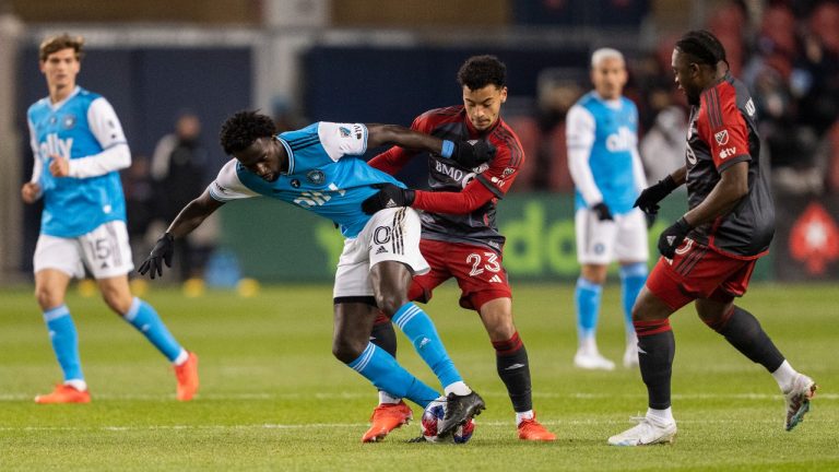 Charlotte FC midfielder Derrick Jones (20) battles for the ball against Toronto FC midfielder Brandon Servania (23) during first half MLS soccer action in Toronto, on Saturday, April 1, 2023. (Andrew Lahodynskyj/THE CANADIAN PRESS)