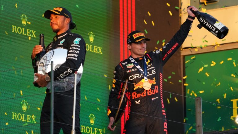 Red Bull driver Max Verstappen of Netherlands, right, and Mercedes driver Lewis Hamilton of Britain celebrate on the podium after the Australian Formula One Grand Prix at Albert Park in Melbourne, Sunday, April 2, 2023. Verstappen won the race and Hamilton took 2nd. (Scott Barbour/AP)