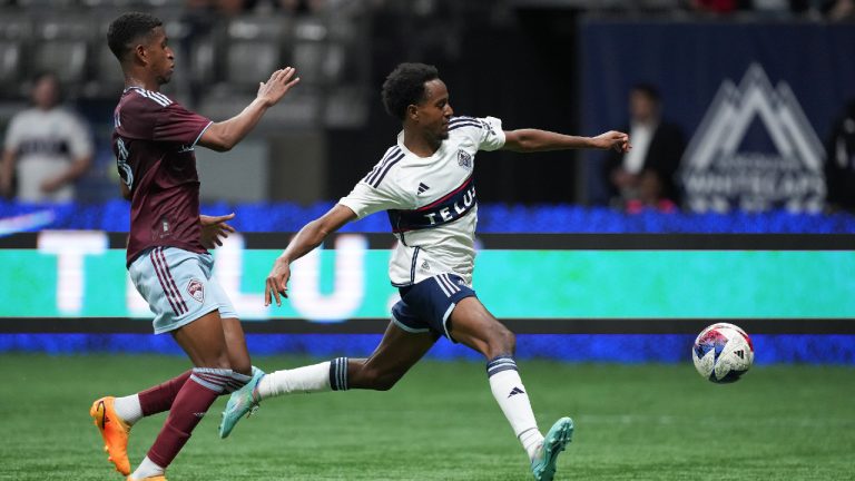 Vancouver Whitecaps' Ali Ahmed, right, chases down the ball against Colorado Rapids' Max and gets a shot on goal during the second half of an MLS soccer game in Vancouver, on Saturday, April 29, 2023. (CP)