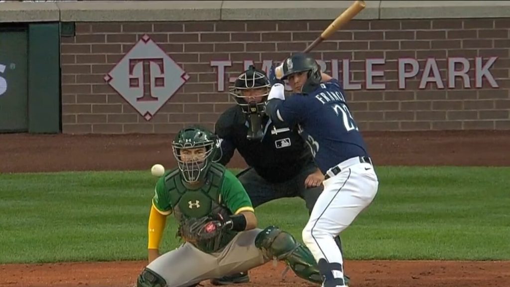 Seattle Mariners' Ty France flips his bat after hitting a home run