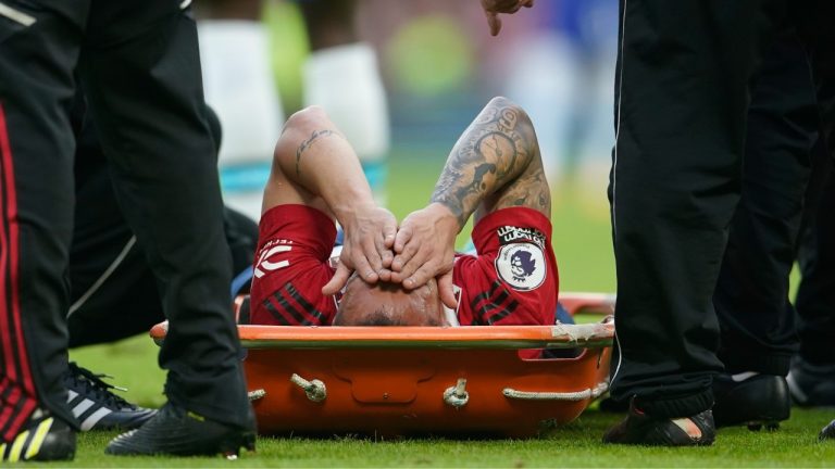 Manchester United's Antony lies on a stretcher during the English Premier League soccer match between Manchester United and Chelsea at the Old Trafford stadium in Manchester, England, Thursday, May 25, 2023. (Dave Thompson/AP)