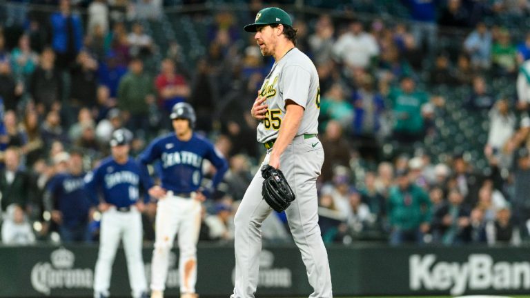 Oakland Athletics relief pitcher Trevor May apologizes to Seattle Mariners' Eugenio Suarez after hitting him with a pitch during the eighth inning of a baseball game Tuesday, May 23, 2023, in Seattle. (Caean Couto/AP)