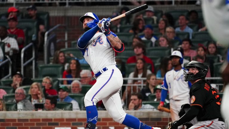 Atlanta Braves pinch hitter Kevin Pillar, left, puts his team ahead with a two-run home run as Baltimore Orioles catcher Adley Rutschman, right, looks on in the eighth inning of a baseball game Saturday, May 6, 2023, in Atlanta. (John Bazemore/AP)