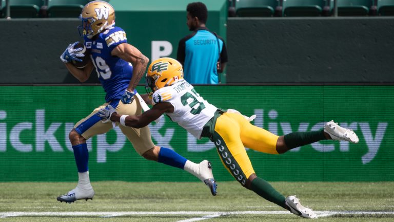 Winnipeg Blue Bombers' Kenny Lawler (89) breaks free from a tackle on Edmonton Elks' Dwayne Thompson II (37) during first half CFL preseason action in Edmonton, Alta., on Saturday May 27, 2023. (Jason Franson/CP)