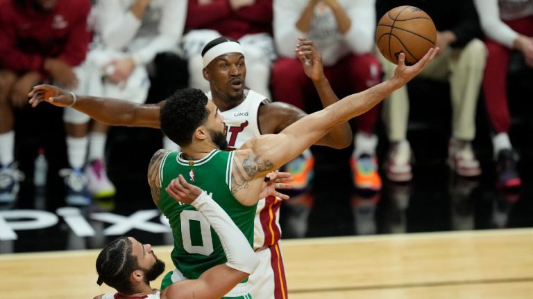 Boston Celtics forward Jayson Tatum (0) drives to the basket over Miami Heat forward Jimmy Butler (22) during the first half of Game 4 during the NBA basketball playoffs Eastern Conference finals, Tuesday, May 23, 2023, in Miami. (Rebecca Blackwell/AP)