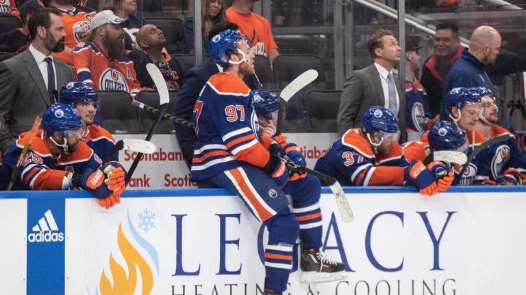 Edmonton Oilers' Connor McDavid (97) sits on the boards  as the Vegas Golden Knights celebrate the win during NHL Stanley Cup second round playoff action in Edmonton on Sunday May 14, 2023. (Jason Franson/CP)