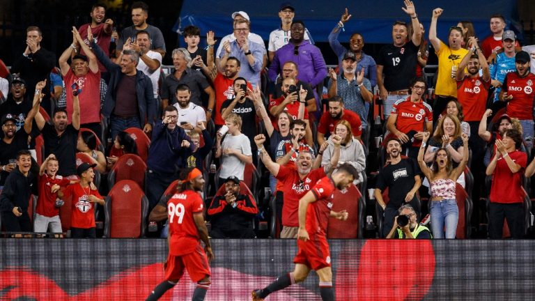 Fans cheer as Toronto FC forward Ifunanyachi Achara (99) and teammate Jesús Jiménez (9) celebrate Jimenez's goal in second half MLS soccer action against the Los Angeles Galaxy in Toronto on Wednesday, Aug. 31, 2022. Cole Burston/THE CANADIAN PRESS