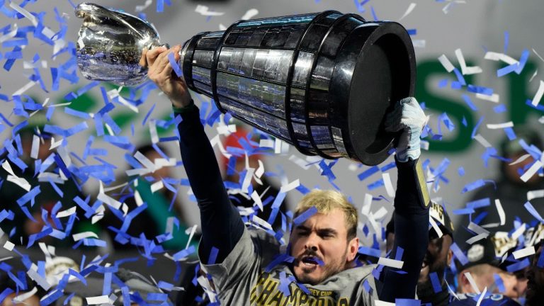 Toronto Argonauts quarterback Chad Kelly hoists the Grey Cup as he celebrates after defeating the Winnipeg Blue Bombers in the 109th Grey Cup at Mosaic Stadium in Regina, Sunday, Nov. 20, 2022. THE CANADIAN PRESS/Frank Gunn