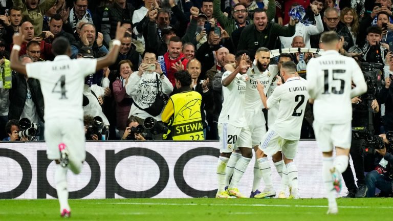 Real Madrid's Karim Benzema, right, celebrates with teammates after scoring the opening goal during the Champions League quarter final first leg soccer match between Real Madrid and Chelsea at Santiago Bernabeu stadium in Madrid, Wednesday, April 12, 2023. (Jose Breton/AP)