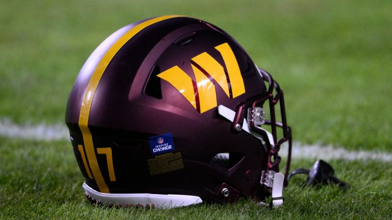 A Washington Commanders helmet is seen before an NFL football game against the New York Giants, Sunday, Dec. 18, 2022, in Landover, Md. Dan Snyder has an agreement in principle to sell the Washington Commanders to a group led by Josh Harris and Mitchell Rales that includes Magic Johnson for a North American professional sports team record $6.05 billion. (AP Photo/Nick Wass, File)