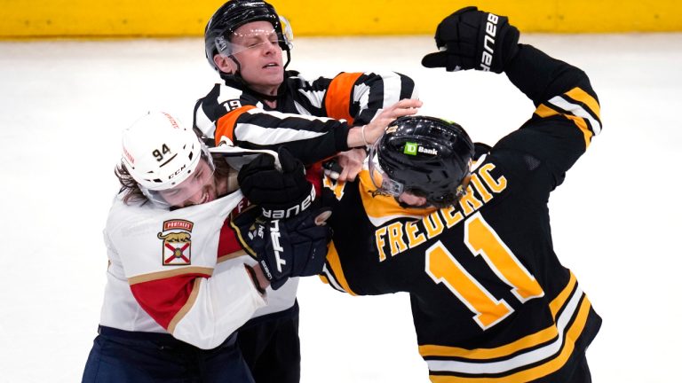 Boston Bruins centre Trent Frederic (11) fights Florida Panthers left wing Ryan Lomberg (94) during the final seconds in Game 2 in the first-round series of the NHL hockey playoffs Wednesday, April 19, 2023, in Boston. (Charles Krupa/AP) 