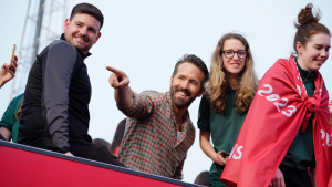 Wrexham co-owner Ryan Reynolds, center, celebrates with members of the Wrexham FC soccer team the promotion to the Football League in Wrexham, Wales, Tuesday, May 2, 2023. (AP)