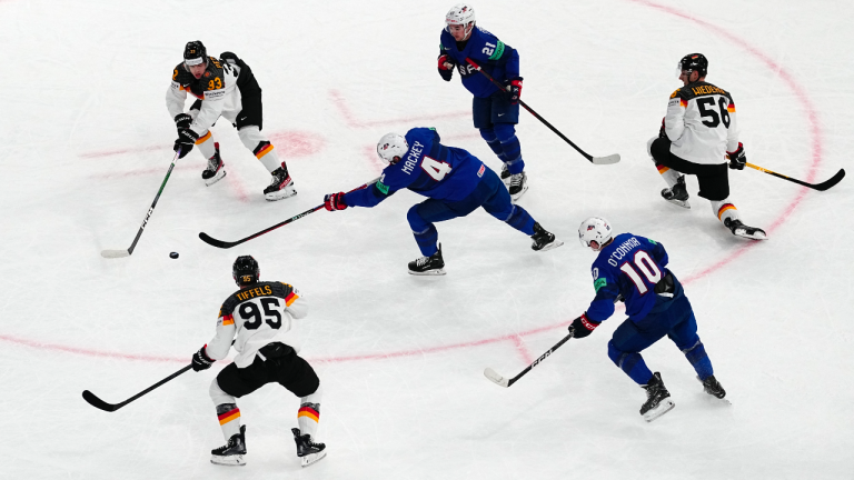 United States Connor Mackey, centre, passes the puck during the group A match between Germany and United States at the ice hockey world championship in Tampere, Finland, Monday, May 15, 2023. (AP Photo/Pavel Golovkin)