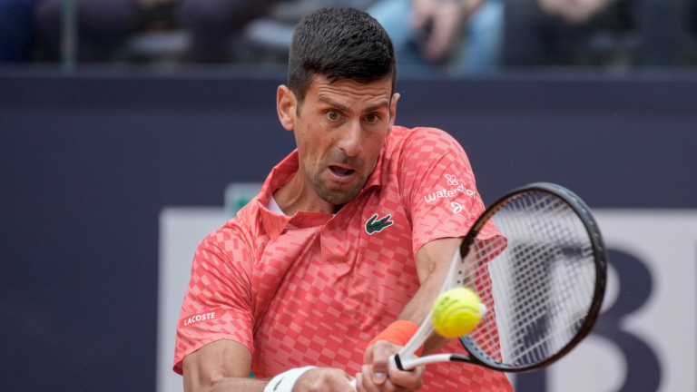 Novak Djokovic of Serbia returns the ball to Cameron Norrie of Britain at the Italian Open tennis tournament, in Rome, Tuesday, May 16, 2023. (AP)