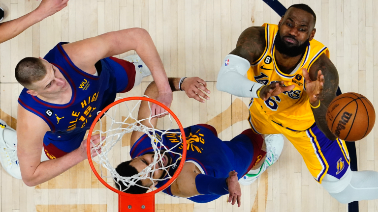 Los Angeles Lakers forward LeBron James (6) loses the ball as Denver Nuggets center Nikola Jokic (15) and Jamal Murray defend during the second half of Game 1 of the NBA basketball Western Conference Finals series, Tuesday, May 16, 2023, in Denver. The Nuggets defeated the Lakers 132-126. (AP Photo/Jack Dempsey)