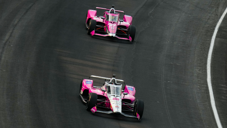 Helio Castroneves, of Brazil, leads Kyle Kirkwood as they head into the first turn during practice for the Indianapolis 500 auto race at Indianapolis Motor Speedway in Indianapolis, Friday, May 18, 2023. (AP Photo/Michael Conroy)