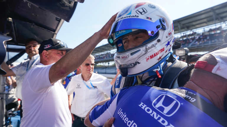 Graham Rahal is consoled by a crew member and his dad, Bobby Rahal, after Rahal was bumped from the Indianapolis 500 auto race at Indianapolis Motor Speedway, Sunday, May 21, 2023, in Indianapolis. (AP Photo/Darron Cummings)