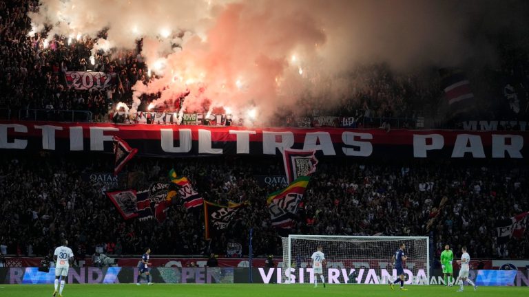 PSG's fans lit flares during the French League One soccer match between Paris Saint-Germain and Marseille at the Parc des Princes in Paris, Sunday, Oct. 16, 2022. (Thibault Camus/AP)